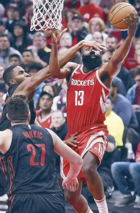  ?? AP ?? Houston Rockets guard James Harden is fouled by Portland Trail Blazers forward Maurice Harkless as he drives to the basket during the second half of NBA action in Portland.