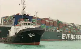  ??  ?? The stranded Ever Given container ship with an Egyptian tug boat in the Suez canal, Egypt, March 2021. Photograph: Suez CANAL/AFP/Getty Images