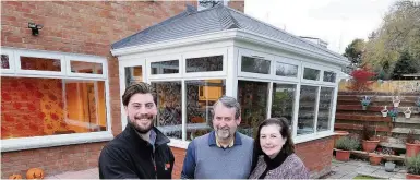  ??  ?? New roof Jason Lisett of Caledonian Windows with happy customers Eugene and Maureen Smyth of Ayr