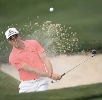  ??  ?? Rickie Fowler hits his third shot from a greenside bunker on the 15th hole Thursday in the first round of the Houston Open in Humble, Texas.