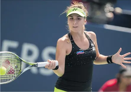  ?? GEOFF ROBINS/ GETTY IMAGES ?? Swiss teenage sensation Belinda Bencic returns a ball to Simona Halep on her way to winning the Rogers Cup women’s title on Sunday. Bencic, the world’s No. 20 player, beat four of the top five seeds — including Serena Williams — en route to the...