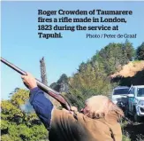  ?? Photo / Peter de Graaf ?? Roger Crowden of Taumarere fires a rifle made in London, 1823 during the service at Tapuhi.