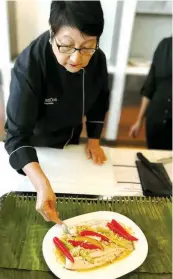  ??  ?? SPICING IT UP Singapore's culinary ambassador Violet Oon spent an afternoon at Discovery Primea's Flame restaurant teaching guests about Singaporea­n food, tradition, and authentici­ty; One of the dishes taught during the class was Singapore's beloved...