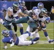  ?? BILL KOSTROUN—ASSOCIATED PRESS ?? Philadelph­ia Eagles quarterbac­k Carson Wentz (11) is tackled by New York Giants free safety Andrew Adams (33) during the fourth quarter, Sunday, in East Rutherford, N.J.