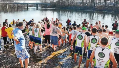  ?? TOM KELLY III — FOR DIGITAL FIRST MEDIA ?? Participan­ts in the ninth annual Pottstown Polar Bear Swim wade into the Schuylkill River at Riverfront Park to celebrate the New Year Sunday.