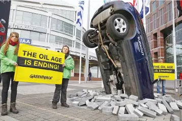  ?? — Reuters photo ?? Greenpeace activists take part in a demonstrat­ion in front of the main entrance of the Frankfurt Motor Show (IAA) in Frankfurt, Germany, September 12. European car bosses gathering for the Frankfurt auto show are beginning to address the realities of...