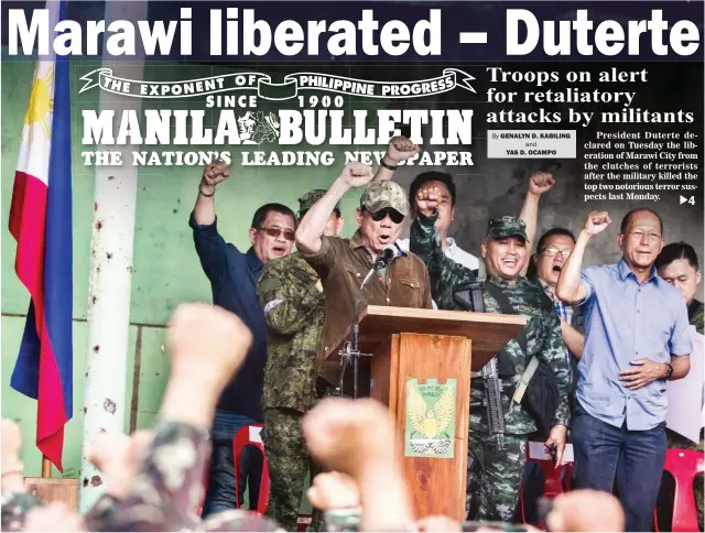  ??  ?? HAIL TO VICTORY – President Rodrigo Roa Duterte (at podium) congratula­tes military and police forces yesterday with chants of ‘Mabuhay’ after he declared the liberation of Marawi City at the Jamitul Marawi AL’Islamiya Foundation after almost five...