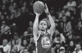  ?? Matthew Stockman / Getty Images ?? Golden State’s Stephen Curry made four 3-pointers as the Warriors scored an NBA-record 51 points in the first quarter at Denver on Tuesday night.