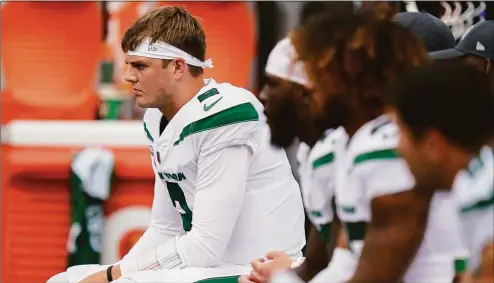  ?? Seth Wenig / Associated Press ?? New York Jets quarterbac­k Zach Wilson sits on the bench during the first half of a game against the Tennessee Titans on Oct. 3, 2021 in East Rutherford, N.J. Wilson has been benched and will be replaced by Mike White as the starter Sunday against the Chicago Bears. Coach Robert Saleh announced the decision Wednesday after evaluating and discussing the situation with his assistants.