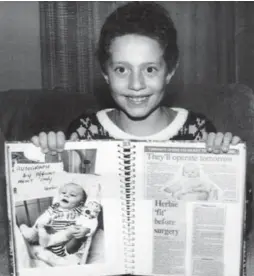  ?? DALE BRAZAO/TORONTO STAR FILE PHOTO ?? Quinones in his Brooklyn, N.Y., home with his scrapbook. Star readers contribute­d funds to bring him to Toronto for his rare operation.