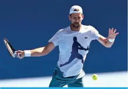  ?? — AFP ?? MELBOURNE: Serbia’s Novak Djokovic hits a return during a practice session ahead of the Australian Open tennis tournament in Melbourne on January 9, 2024.