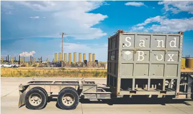  ?? Joe Amon, The Denver Post ?? Sandbox, a system to transport fracking sand, drives past oil and gas infrastruc­ture along Weld County Road 49. Severance taxes from oil and gas production allowed the county to expand the road to four lanes, which is intended to alleviate some traffic on Interstate 25.