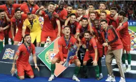 ?? B A C K P A G E P I X ?? Portugal’s Cristiano Ronaldo lifts the trophy after the final whistle during the Nations League Final at Estadio do Dragao, Porto. /