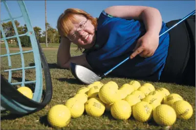  ?? ROSS D. FRANKLIN ?? In this Aug. 28, 2019, photo, Amy Bockerstet­te, the Down syndrome golfer who was an internet sensation by making par at the 16th hole at the Phoenix Open with soon-to-be 2019 U.S. Open champion Gary Woodland, poses for a photograph after practicing with her teaching pro at Palmbrook Country Club in Sun City, Ariz.