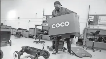  ?? Gary Coronado/Los Angeles Times/TNS ?? Grant Rodriguez, manager of maintenanc­e repair overhaul, assembles a robot at Coco facility in Culver City, California.