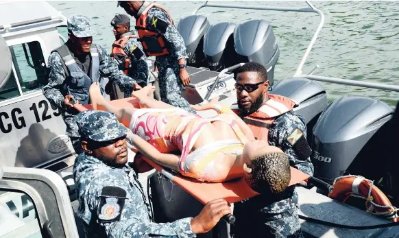  ??  ?? Members of the JDF remove one of the ‘bodies’ from the sea during the Water and Aviation Emergency Simulation at the Norman Manley Internatio­nal Airport last Thursday.