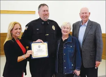  ??  ?? After Leslie Rutledge, Arkansas attorney general, presented Police Chief Steven Grizzle (second from left) with the 2020 Benton County Law Enforcemen­t Officer of the Year Award at Decatur City Hall May 10, Grizzle took a moment to include his parents, Kay and Steven Grizzle, in a group photo.
(NWA Democrat-Gazette/Mike Eckels)