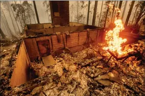  ?? AP PHOTO BY NOAH BERGER ?? Flames burn at a home leveled by the Creek Fire along Highway 168 on Tuesday, Sept. 8, in Fresno County, Calif.