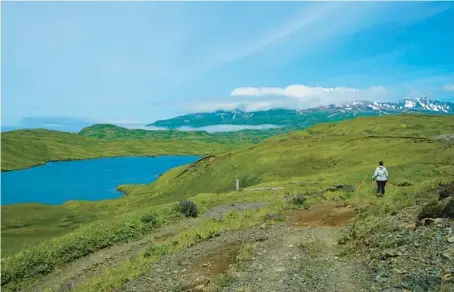  ?? NICOLE EVATT 2021 ?? A hiker en route to Lake Bonnie Rose, one of many scenic hiking options on Adak Island, part of the far-flung Aleutian Islands in Alaska.