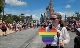  ?? Photograph: Octavio Jones/Reuters ?? A Walt Disney World photograph­er holds a Pride rainbow-coloured Mickey Mouse cutout at the Walt Disney World Magic Kingdom theme park in Orlando, Florida.