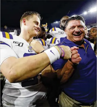  ?? KEVIN C. COX / GETTY IMAGES ?? Quarterbac­k Joe Burrow gets a fist bump from coach Ed Orgeron after leading LSU to a 46-41 victory over host Alabama in an SEC showdown with Heisman and national title implicatio­ns.