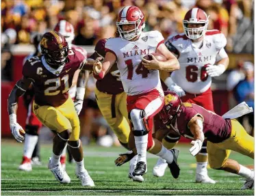  ?? HANNAH FOSLIEN / GETTY IMAGES ?? Miami quarterbac­k Gus Ragland, running against Minnesota earlier this season, has thrown for 1,017 yards with eight touchdowns and two intercepti­ons this season.