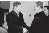  ?? AP/KIM KWANG HYON ?? Song Tao (left), special envoy to President Xi Jinping, is greeted by North Korean official Ri Chang Gun in Pyongyang on Friday.