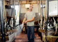  ?? AP/HEATHER AINSWORTH ?? Dan Dimon, 28, works in the milking parlor at The Carley Farms in Pompey, N.Y.