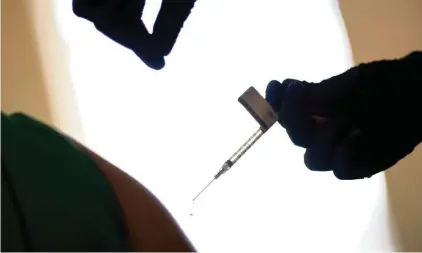  ?? DAVID GOLDMAN AP ?? A droplet falls from a syringe after a healthcare worker was injected with the Pfizer-BioNTech COVID-19 vaccine at a hospital in Providence, R.I., on Tuesday. The State Department’s medical unit said the department had received only 5% of the vaccine that was expected, a source said.