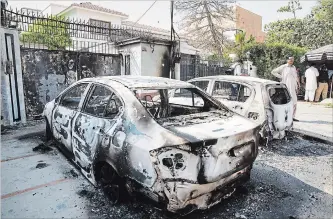  ?? SAINYA BASHIR NEW YORK TIMES ?? Burned-out cars sit outside the Chinese Consulate in Karachi, Pakistan, after militants attacked it on Friday.