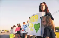  ?? MARIE D. DE JESUS/HOUSTON CHRONICLE ?? Andi Lewis, director of the Kingwood High School Fillies dance team, brought team members to Santa Fe High School in Texas in support of students who were returning for their first day of classes Tuesday.