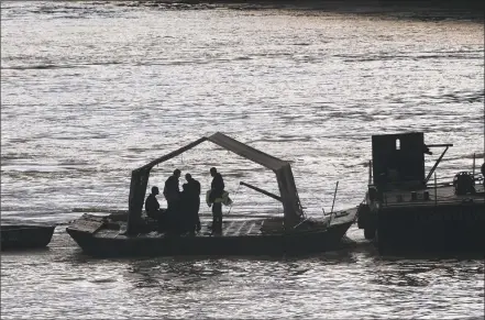  ?? Getty Images / Getty Images ?? Hungarian authoritie­s on Thursday search for remains from a tourist boat that capsized on the Danube River the night before, killing at least seven people, in Budapest, Hungary.