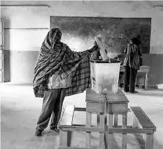  ??  ?? A member of the Maasai and Kikuyu tribe votes at Kajiado Primary School in Masailand. — AFP photo