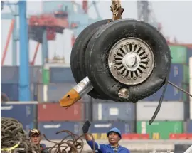  ?? AP ?? A crane moves a pair of wheels recovered from the Lion Air jet that crashed into the Java Sea for further investigat­ion at Tanjung Priok Port in Jakarta, Indonesia.