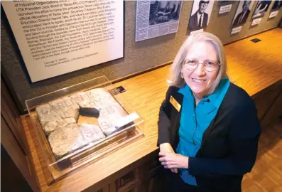  ?? The Dallas Morning News via AP ?? Archivist Betty Shankle poses next to a broken marble marker on Oct. 24 with the inscriptio­n “Carlisle Military Academy 1906” in the University of Texas at Arlington Special Collection­s in Arlington, Texas. The stone with one of the earliest names of...