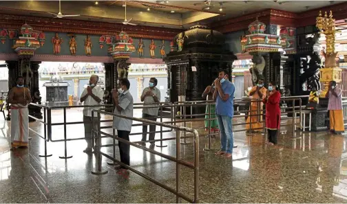  ??  ?? Paying homage: Hindu devotees praying at the Sri Sundaraja Perumal temple in Klang as non-Islamic houses of worship were allowed to reopen.