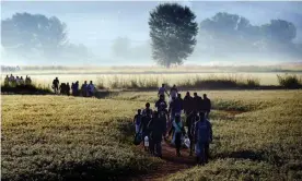  ??  ?? Syrian refugees attempting to cross the border between Greece and Macedonia in 2015. Photograph: Aris Messinis/AFP/Getty Images