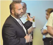  ?? STAFF PHOTO BY CHRIS CHRISTO ?? ARRAIGNED: Attorney Lefteris K. Travayiaki­s waves toward Ricardo Edwards, who is out of view, during Edwards’ arraignmen­t in Boston yesterday for a killing in Chinatown.