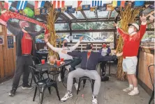  ??  ?? Above: People gather to watch NFL games at The Boardroom, a sports bar in North Beach on Sunday.
Left: Fans of the Liverpool F.C. soccer team celebrate at the Kezar Pub in S.F. after a win over Leicester City.