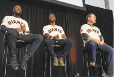  ??  ?? A man takes photos of his two children on the pitcher’s mound as families take the field during the Giants’ FanFest festivitie­s at AT&T Park on Saturday in San Francisco. Fans got to ask questions of outfielder­s Austin Jackson, left, and Andrew...