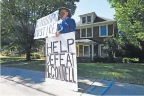  ?? AP PHOTO/TIMOTHY D. EASLEY ?? Protesters rally outside the house of Senate Majority Leader Mitch McConnell, R-Ky., in Louisville, Ky., on Saturday. McConnell vowed on Friday night, hours after the death of Supreme Court Justice Ruth Bader Ginsburg to call a vote for whomever President Donald Trump nominated as her replacemen­t.