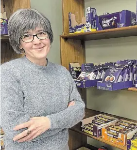  ?? JULIA LOVETTSQUI­RES METROLAND ?? Andrea Parcey spends her days surrounded by chocolate and other delights at Opies Waterdown.