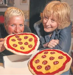  ?? Pictures: Kris Miller. ?? Marie Fagan, left, of Titanic Pizza and Carnoostiv­al organiser Suzi Caesar practise their throwing skills ahead of the big day.