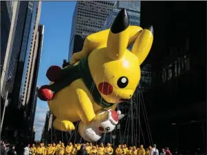  ?? The Associated Press ?? PIKACHU: A Pikachu balloon makes its way down Sixth Avenue during the Macy’s Thanksgivi­ng Day Parade on Thursday in New York.