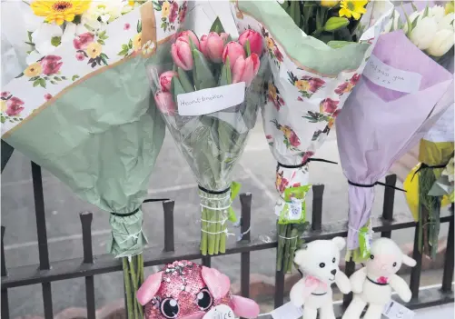  ?? PRESSEYE ?? Aftermath: Floral tributes are left at the scene of the fatal collision on Springhill Avenue in west Belfast