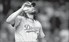  ?? David Zalubowski Associated Press ?? DODGERS CLOSER Kenley Jansen walks off the mound at Coors Field after a four-out save against the Colorado Rockies in high-altitude Denver.