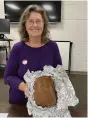  ?? (Special to The Commercial) ?? Jody Stout shows an example of quick bread during a recent presentati­on at Heart-N-Hands Extension Homemakers Club.