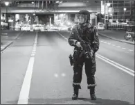  ?? AP/FREDRIK VARFJELL ?? A Norwegian officer stands guard as police cordon off the area around a subway station on a busy commercial street in Oslo on Saturday night after finding what they described as a “bomb-like” device.