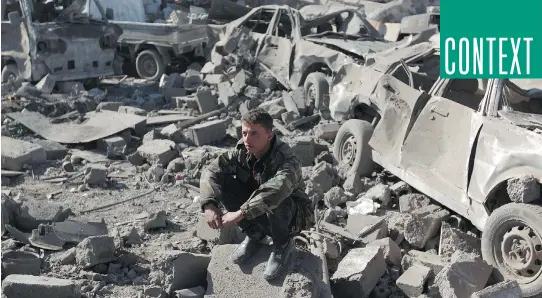  ?? MO H A MMED H U WA I S / A F P/ G E T T Y I MAG E S ?? A member of the Yemeni security forces sits above debris at the site of a Saudi air strike against Houthi rebels on Thursday.