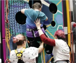  ?? ?? ●●Cub Max is given a helping hand to climb the walls by Cub leaders Ka Suzi Tighe and Akela Catherine Smyth
